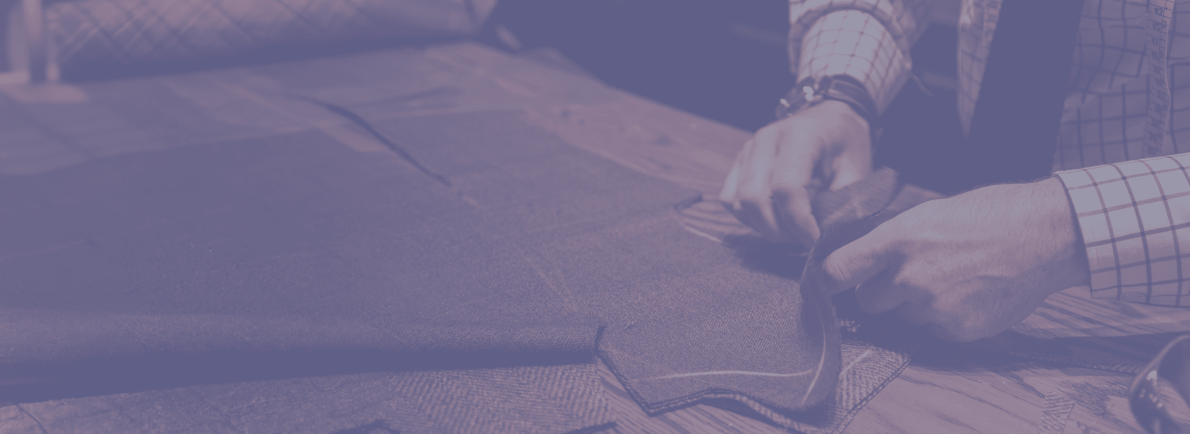 An image of an elderly tailor working with cloth